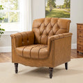 Fauteuil club en similicuir capitonné avec clous décoratifs et pieds tournés en bois