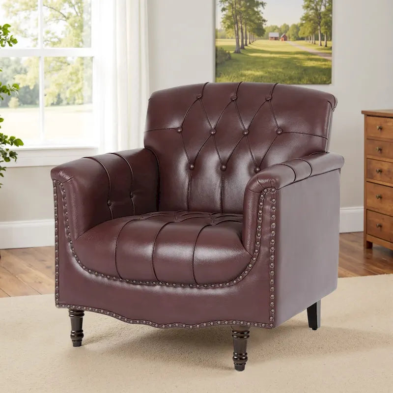 Fauteuil club en similicuir capitonné avec clous décoratifs et pieds tournés en bois