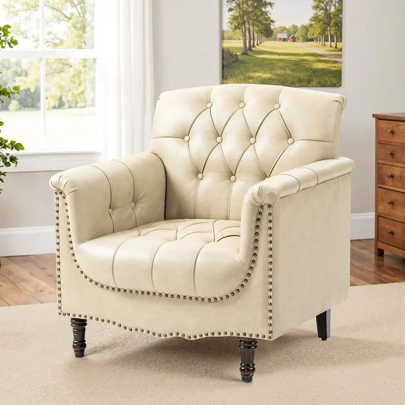 Fauteuil club en similicuir capitonné avec clous décoratifs et pieds tournés en bois