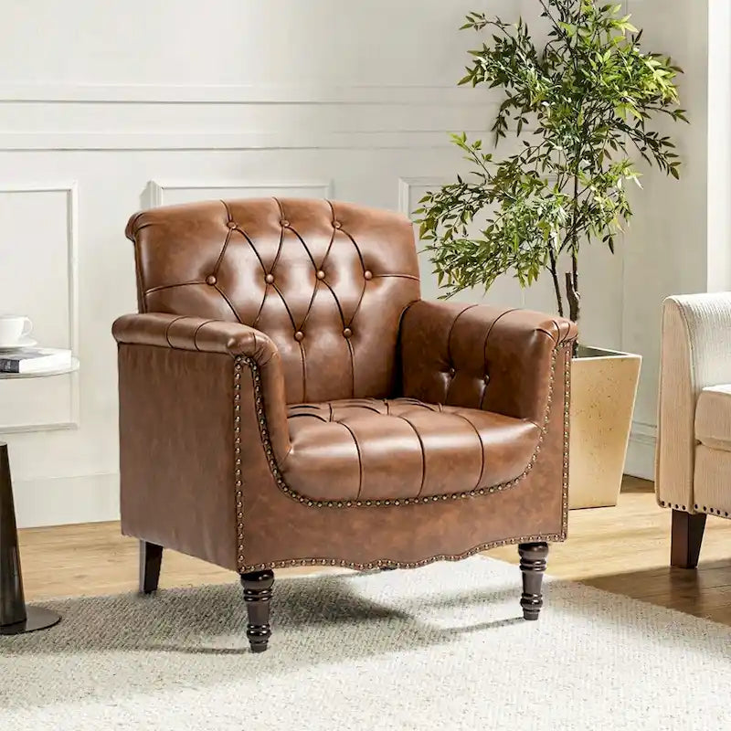 Fauteuil club en similicuir capitonné avec clous décoratifs et pieds tournés en bois