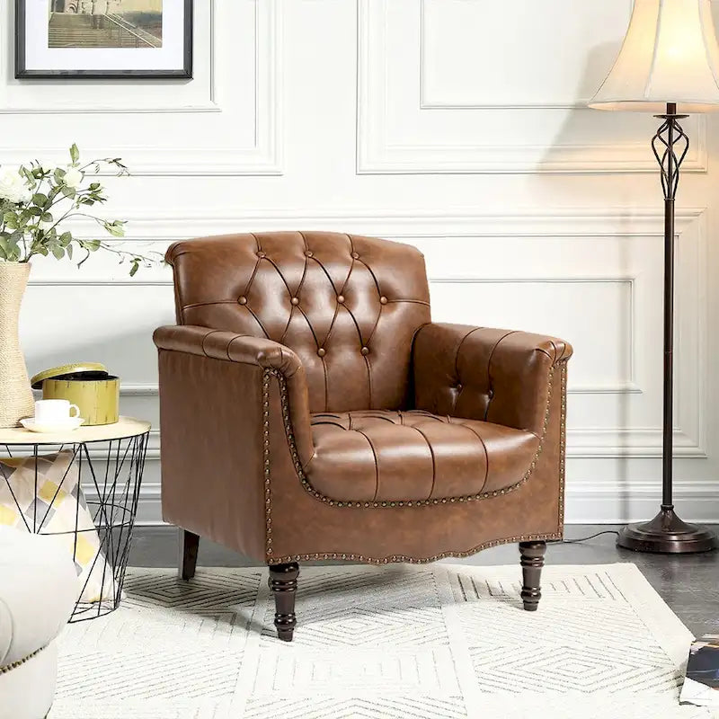 Fauteuil club en similicuir capitonné avec clous décoratifs et pieds tournés en bois