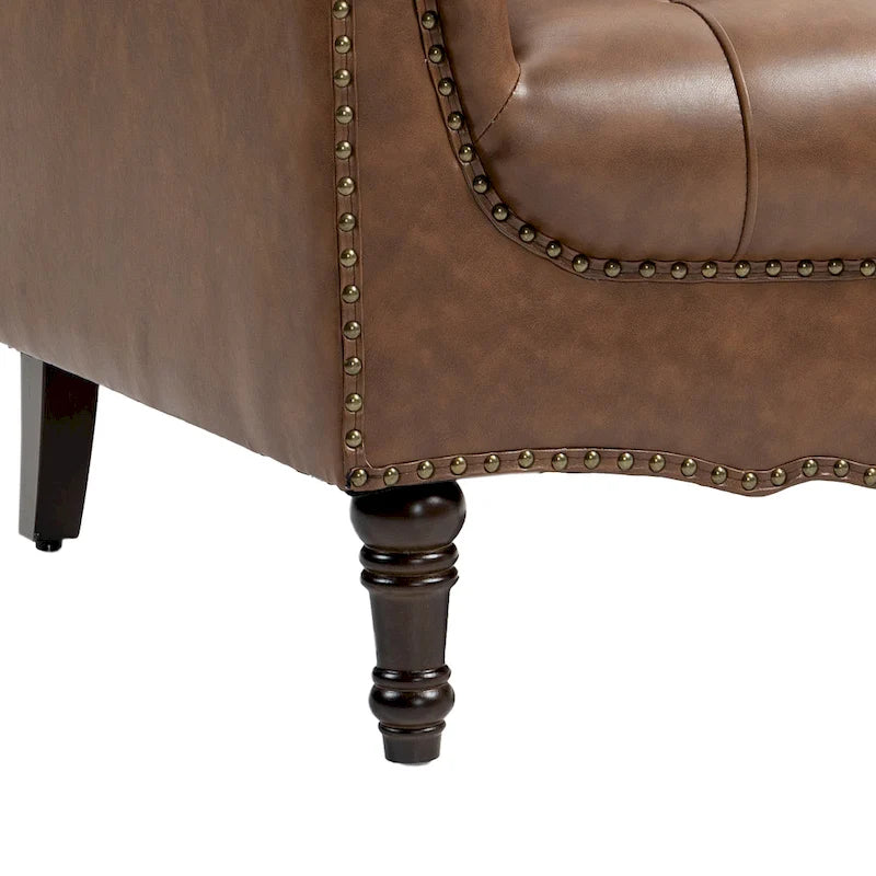 Fauteuil club en similicuir capitonné avec clous décoratifs et pieds tournés en bois