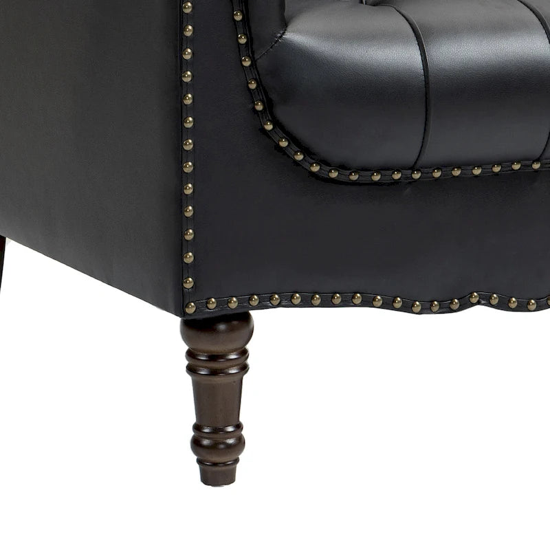 Fauteuil club en similicuir capitonné avec clous décoratifs et pieds tournés en bois