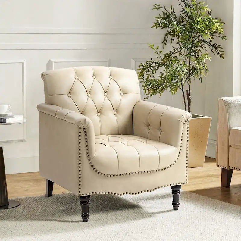 Fauteuil club en similicuir capitonné avec clous décoratifs et pieds tournés en bois