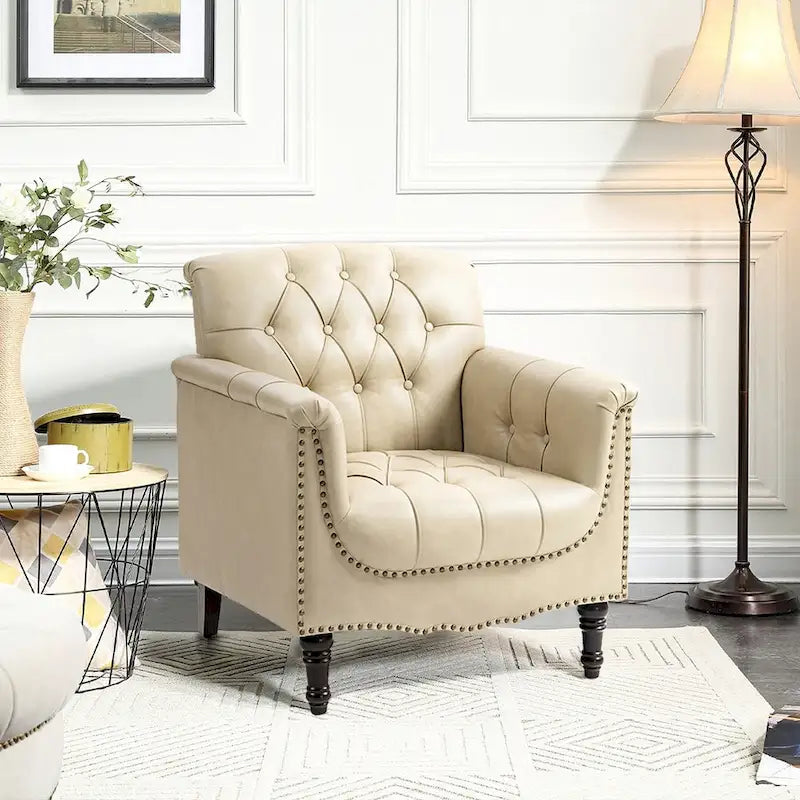 Fauteuil club en similicuir capitonné avec clous décoratifs et pieds tournés en bois