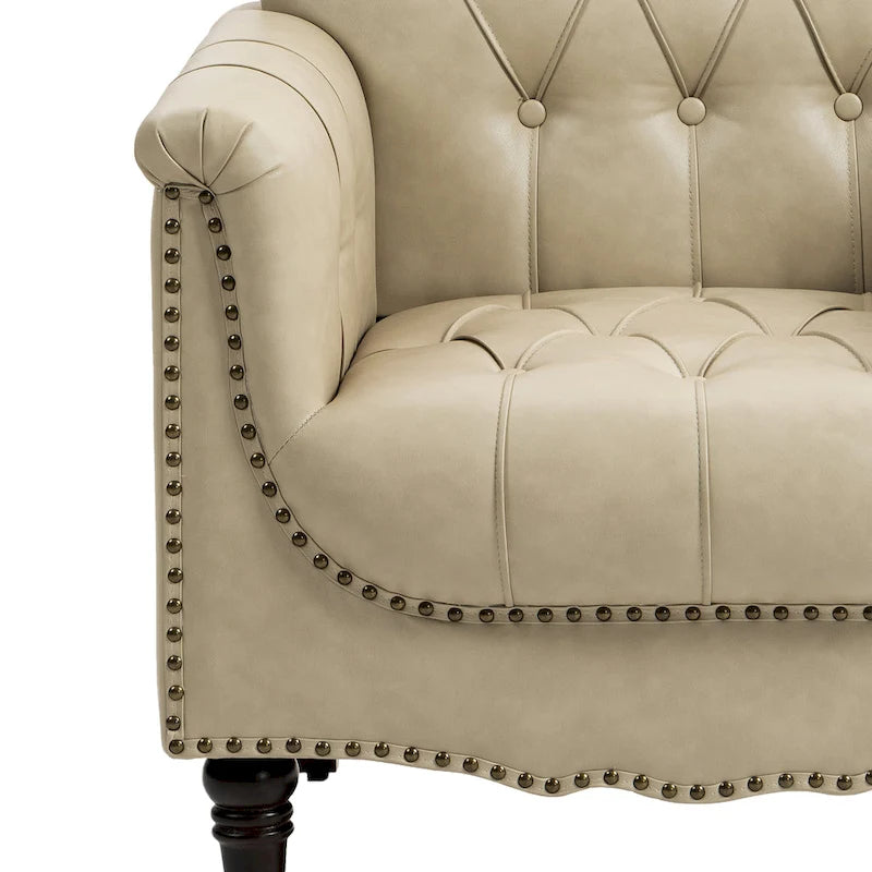 Fauteuil club en similicuir capitonné avec clous décoratifs et pieds tournés en bois