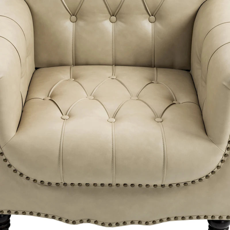 Fauteuil club en similicuir capitonné avec clous décoratifs et pieds tournés en bois