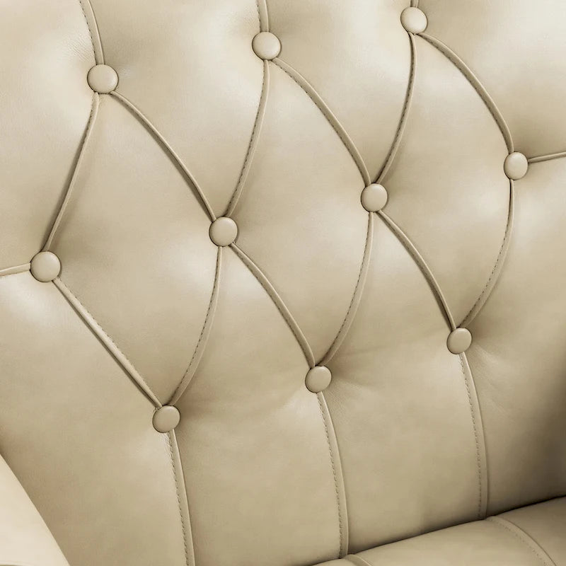 Fauteuil club en similicuir capitonné avec clous décoratifs et pieds tournés en bois