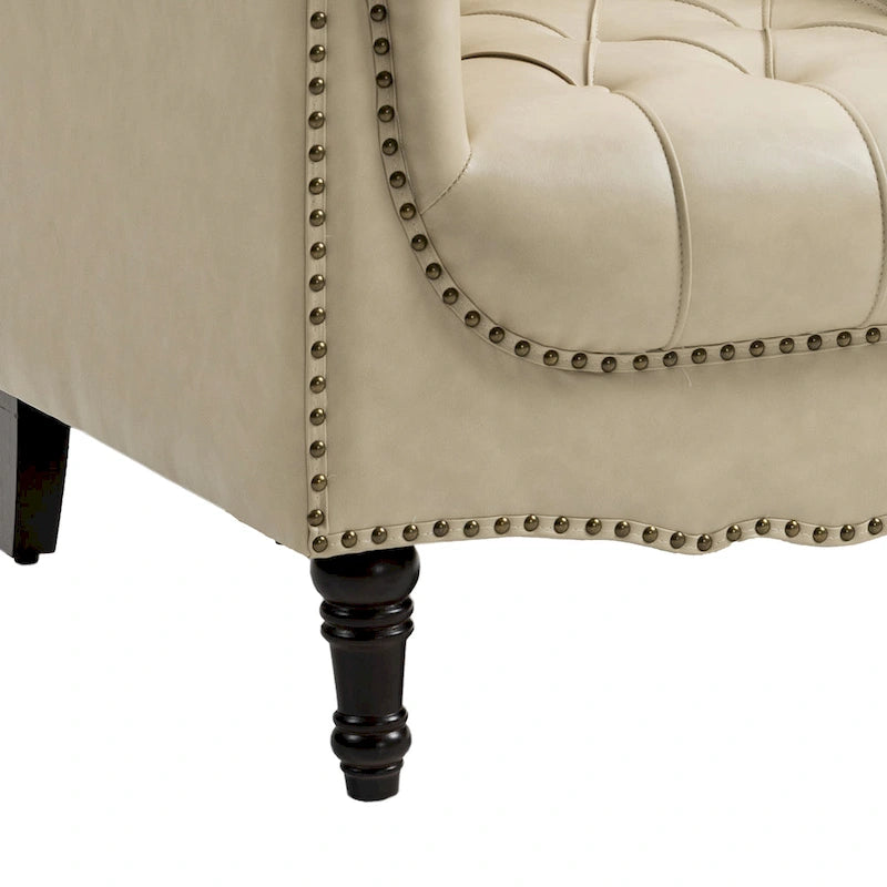 Fauteuil club en similicuir capitonné avec clous décoratifs et pieds tournés en bois