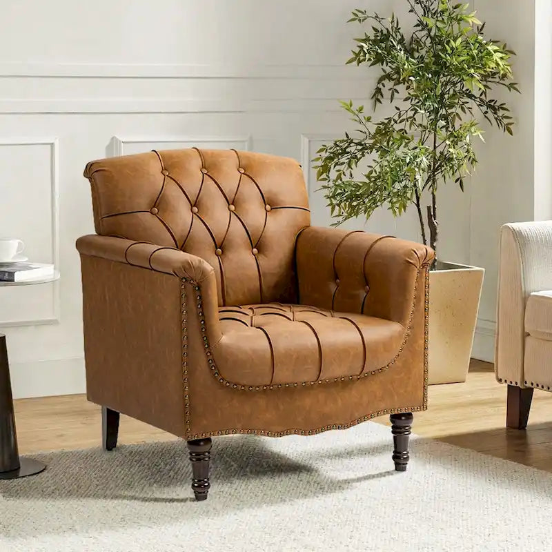 Fauteuil club en similicuir capitonné avec clous décoratifs et pieds tournés en bois