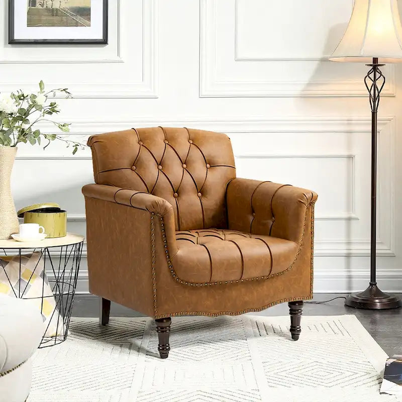 Fauteuil club en similicuir capitonné avec clous décoratifs et pieds tournés en bois